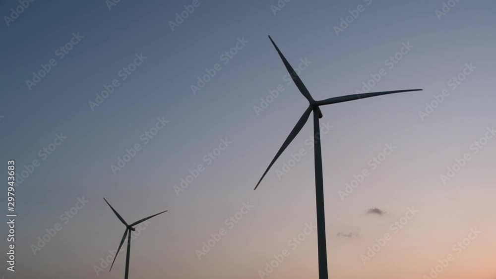 Wind Turbines Silhouette against the Blue-sky during Sunset, clean alternative energy in Thailand and mainland Southeast Asia. Wind Turbines Silhouette against the Blue-sky during Sunset, clean alternative energy in Thailand and mainland Southeast Asia.