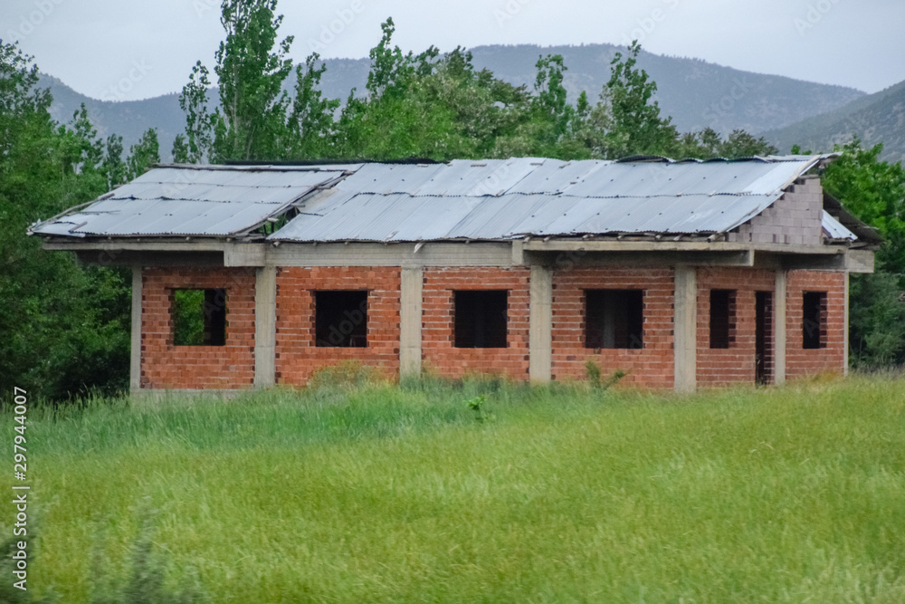 Unfinished brick shed in a clearing. Unfinished brick shed in a clearing.