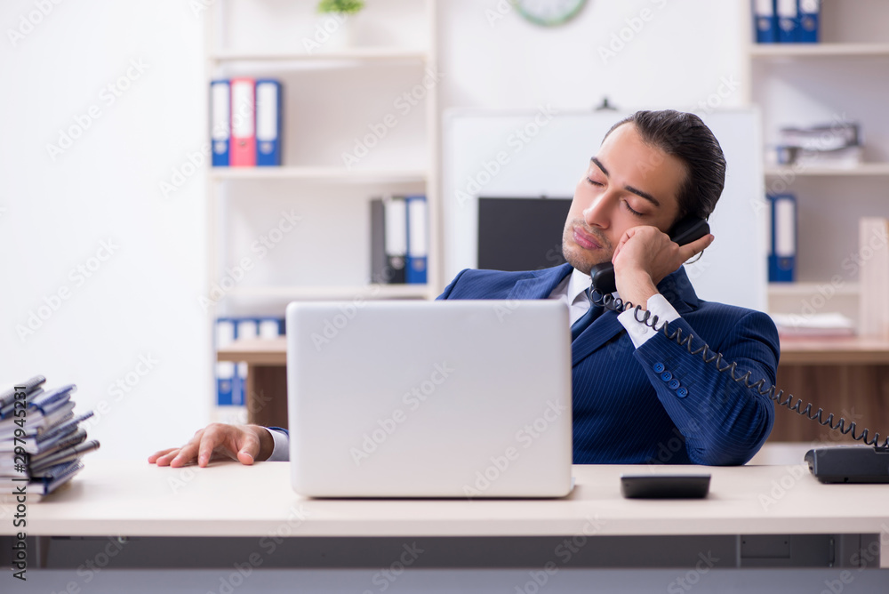 Young male businessman working in the office Young male businessman working in the office