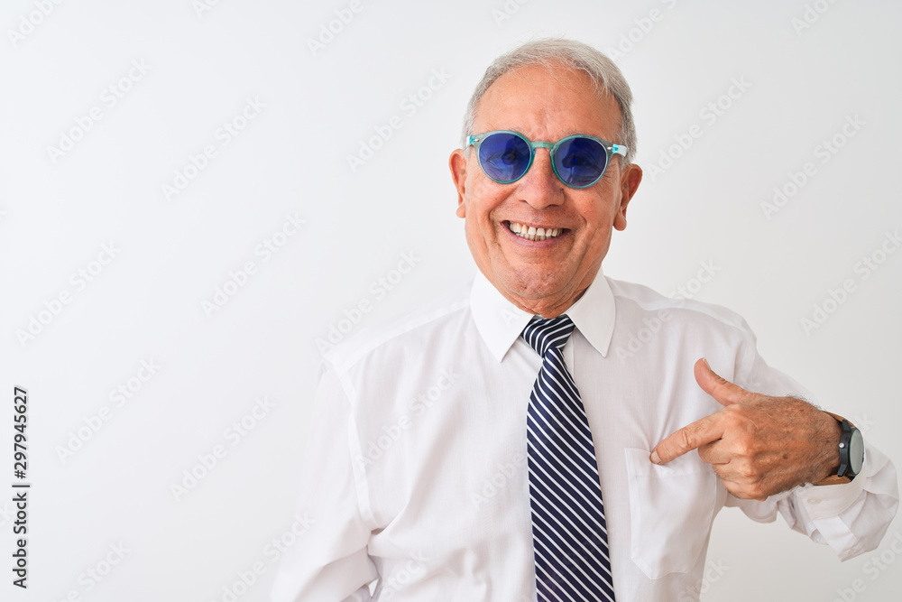 Senior grey-haired businessman wearing tie and sunglasses over isolated white background with surprise face pointing finger to himself