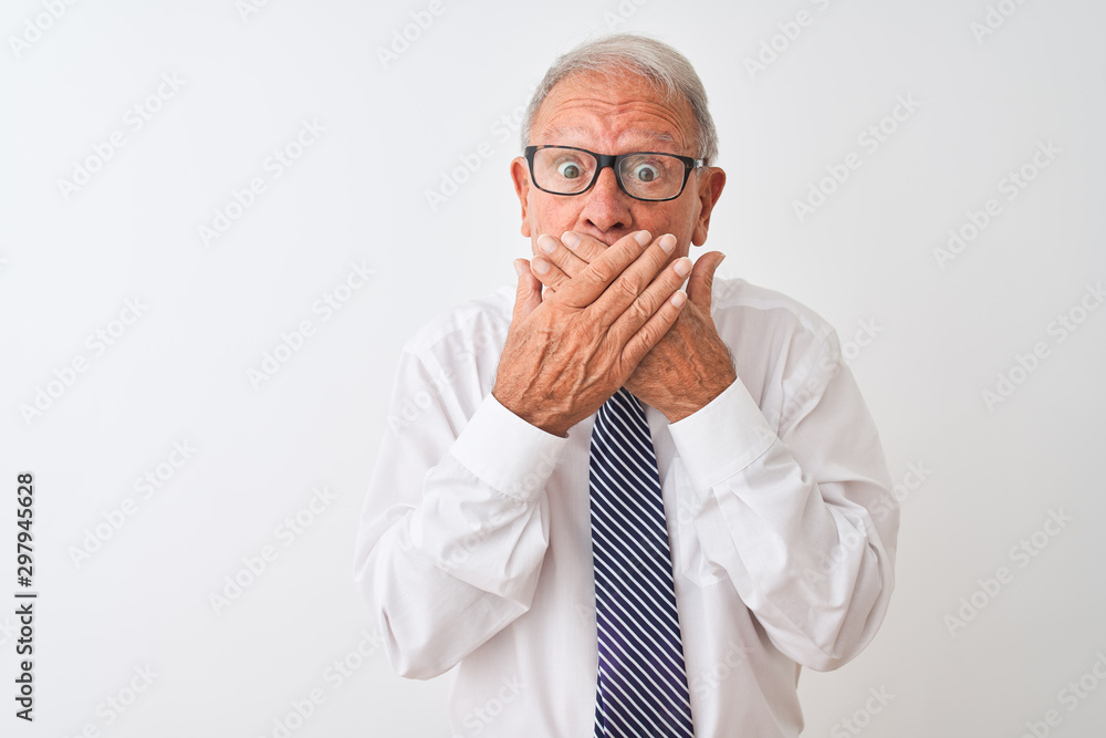 Senior grey-haired businessman wearing tie and glasses over isolated white background shocked covering mouth with hands for mistake. Secret concept. Senior grey-haired businessman wearing tie and glasses over isolated white background shocked covering mouth with hands for mistake. Secret concept.
