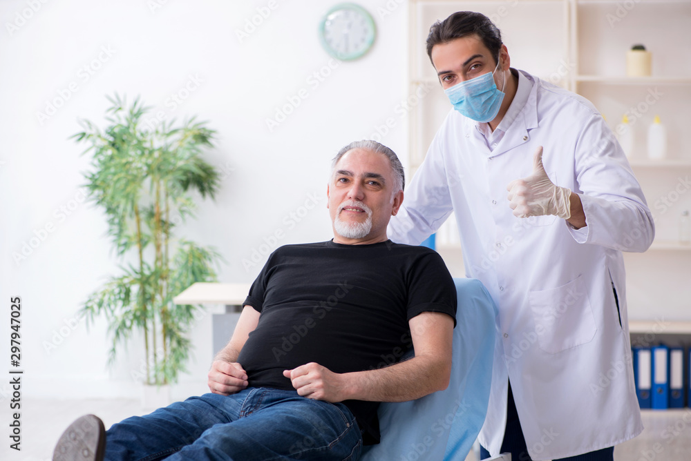 Fototapeta premium Old man visiting young doctor for plastic surgery