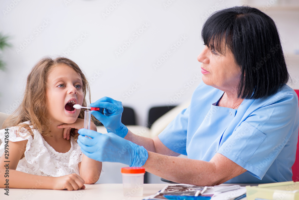 Little girl visiting old female doctor Little girl visiting old female doctor