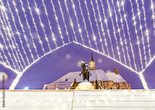 winter in Cluj-Napoca, Saint Michael church and King Matthias statue in snow, Romania photo