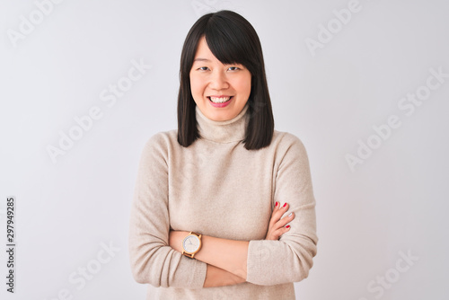 Young beautiful chinese woman wearing turtleneck sweater over isolated white background happy face smiling with crossed arms looking at the camera. Positive person. © Krakenimages.com