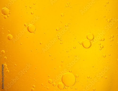 Bubbles on beer background. Oil drop shape on yellow background.Golden circle bubble water pattern.