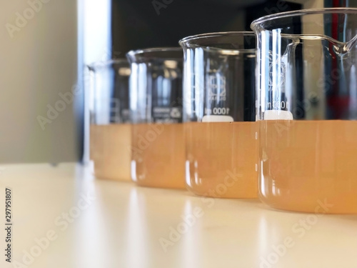 Waste water sample in beakers coagulation and flocculation method with Ferric chlorine and using Jar test for forming precipitation and reduced turbidity calibration range. Use for science background. photo