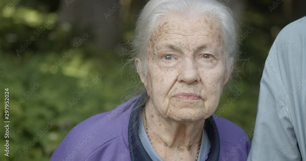 Old woman face holding her husbands , close up, slow motion Old woman face holding her husbands , close up, slow motion