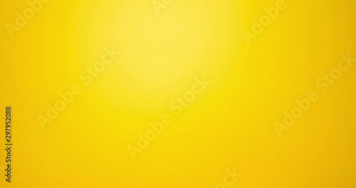 Woman hand show thumbs down gesture. Female hand over yellow background photo