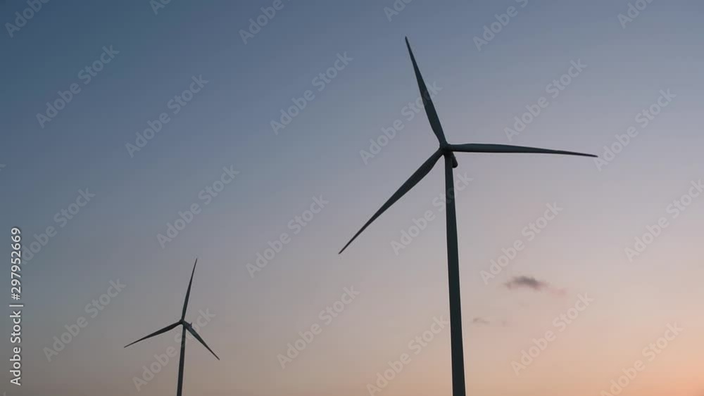 Wind Turbines Silhouette against the Blue-sky during Sunset, clean alternative energy in Thailand and mainland Southeast Asia. Wind Turbines Silhouette against the Blue-sky during Sunset, clean alternative energy in Thailand and mainland Southeast Asia.