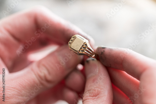 Close-Up Of Jewelry Hands Maker Using Polishing Machine