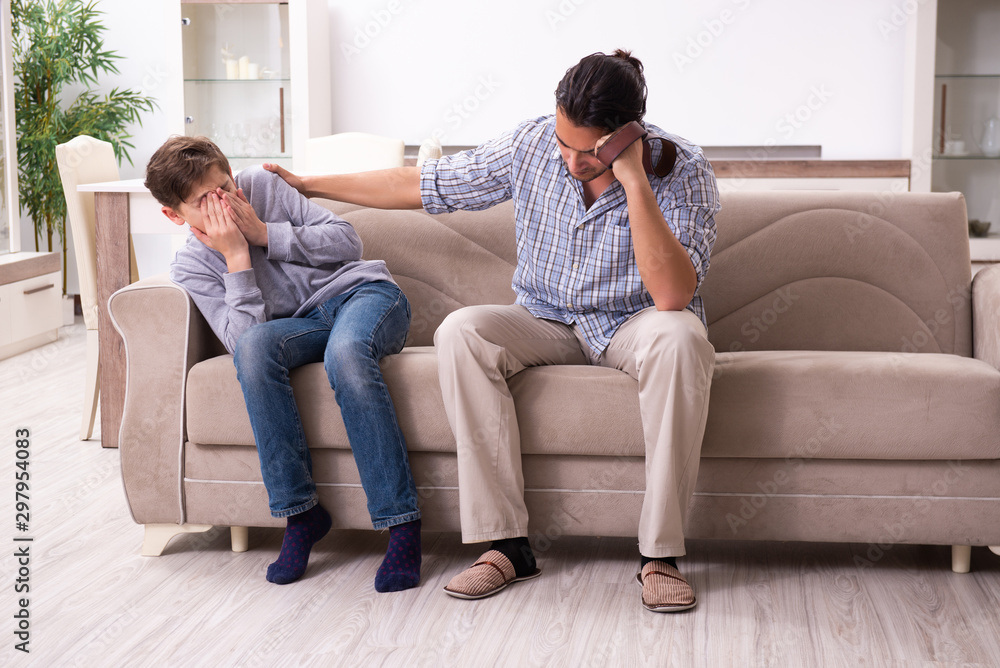 Fototapeta premium Father beating and punishing his sone