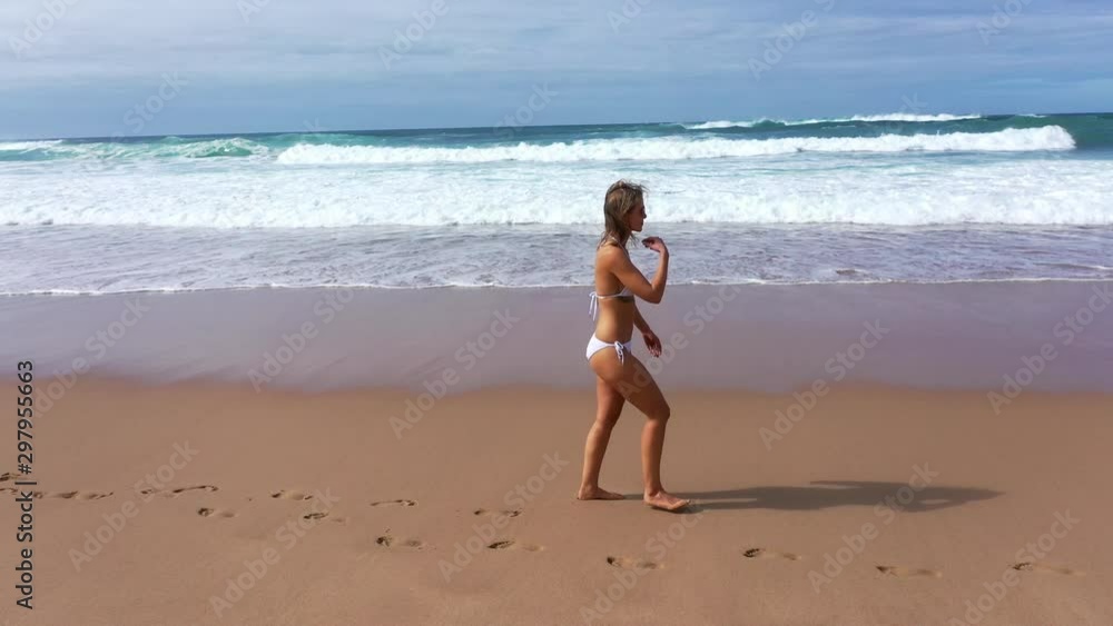 Pretty woman on summer vacation at the beach - aerial drone footage Pretty woman on summer vacation at the beach - aerial drone footage