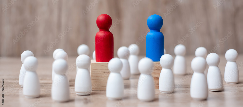 Red and Blue businessman leader with crowd of wooden employee. leadership, business, team, teamwork and fighting concept Red and Blue businessman leader with crowd of wooden employee. leadership, business, team, teamwork and fighting concept