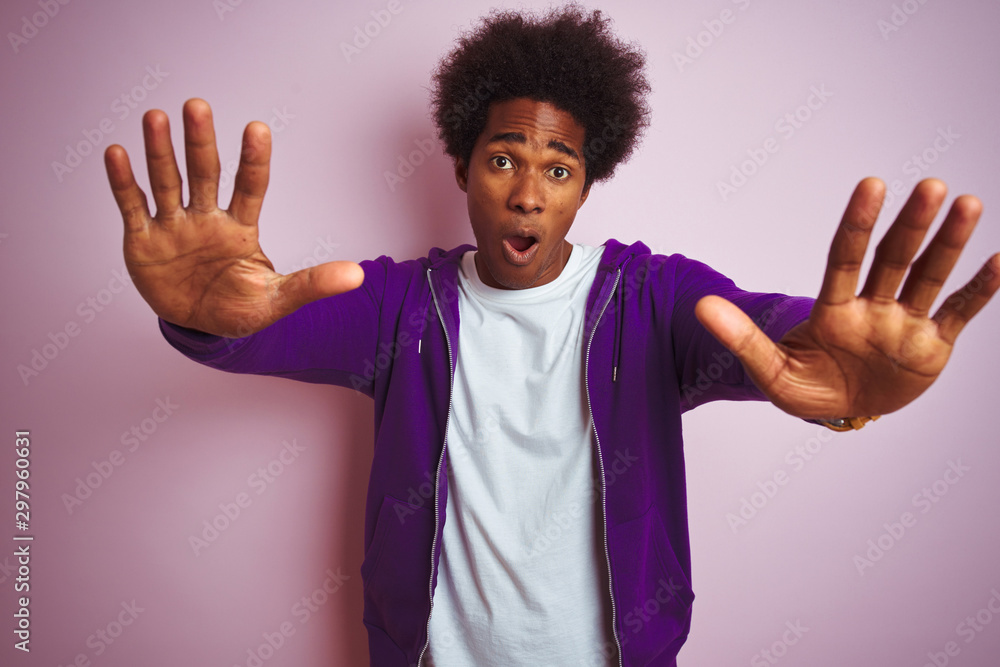 Young african american man wearing purple sweatshirt standing over isolated  pink background doing stop gesture with hands palms, angry and frustration  expression Stock Photo | Adobe Stock