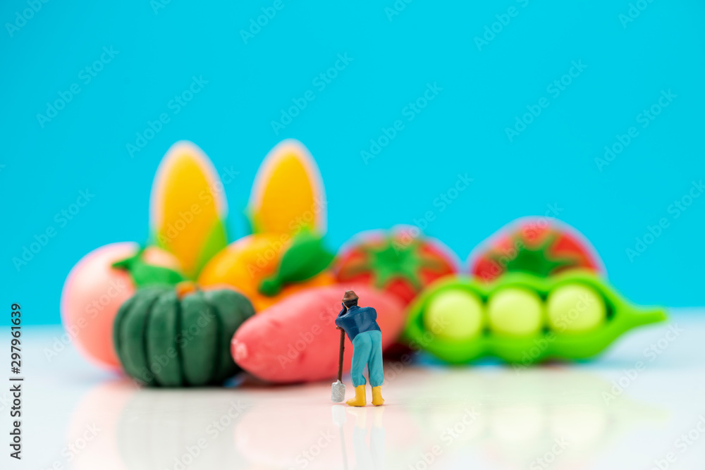 Miniature toys studio set up - a farmer looks at his produce. Miniature toys studio set up - a farmer looks at his produce.
