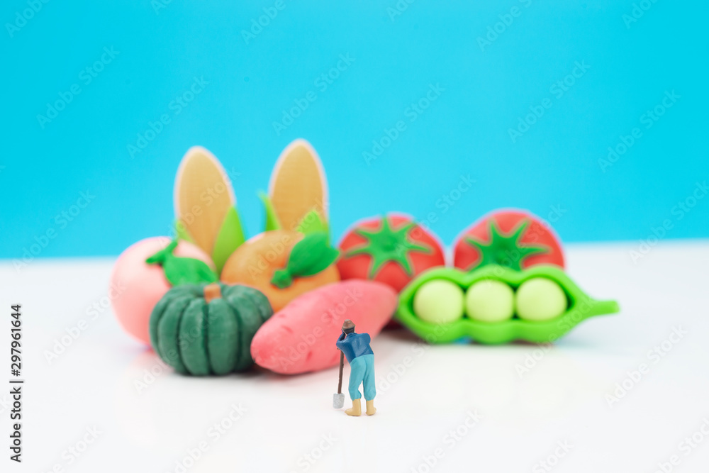 Miniature toys studio set up - a farmer looks at his produce. Miniature toys studio set up - a farmer looks at his produce.