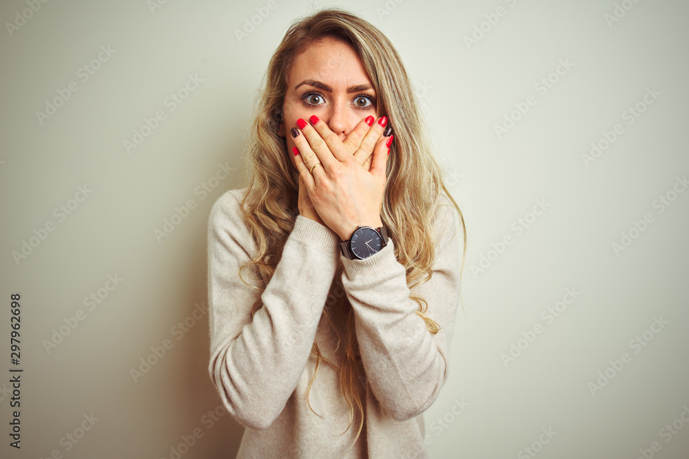 Beautiful woman wearing winter turtleneck sweater over isolated white background shocked covering mouth with hands for mistake. Secret concept. Beautiful woman wearing winter turtleneck sweater over isolated white background shocked covering mouth with hands for mistake. Secret concept.