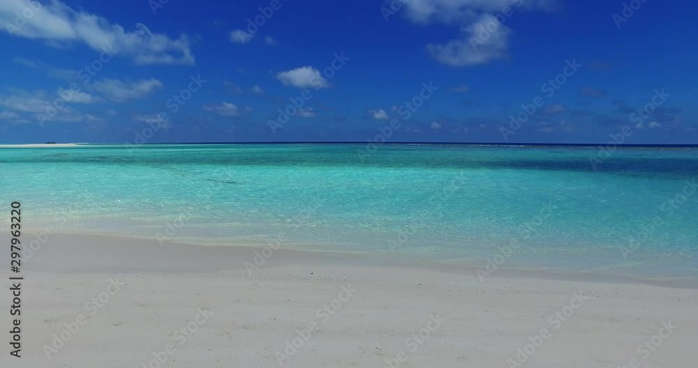 Beautiful white sand beach and turquoise clean water with clear blue sky in Florida - Steady shot
