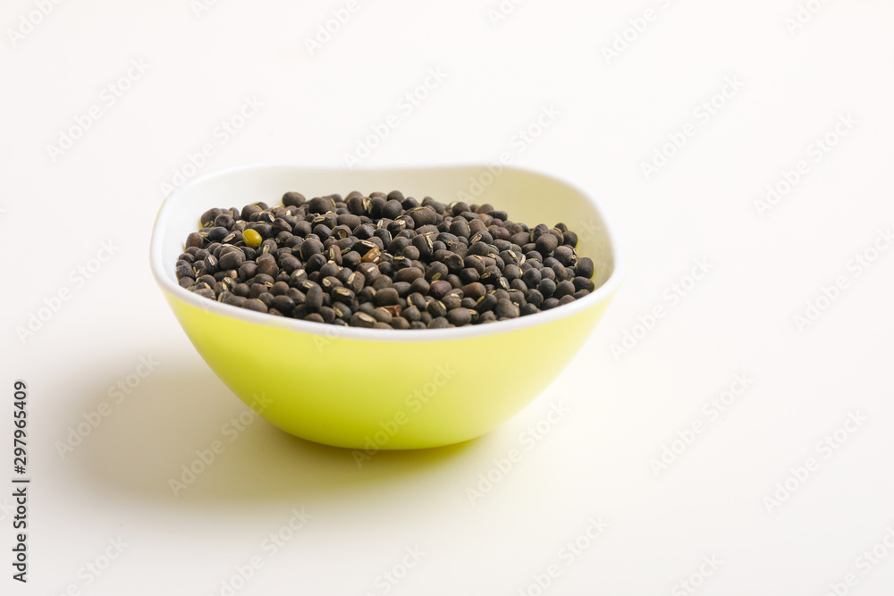 black gram seed or udad beans in bowl on white background black gram seed or udad beans in bowl on white background