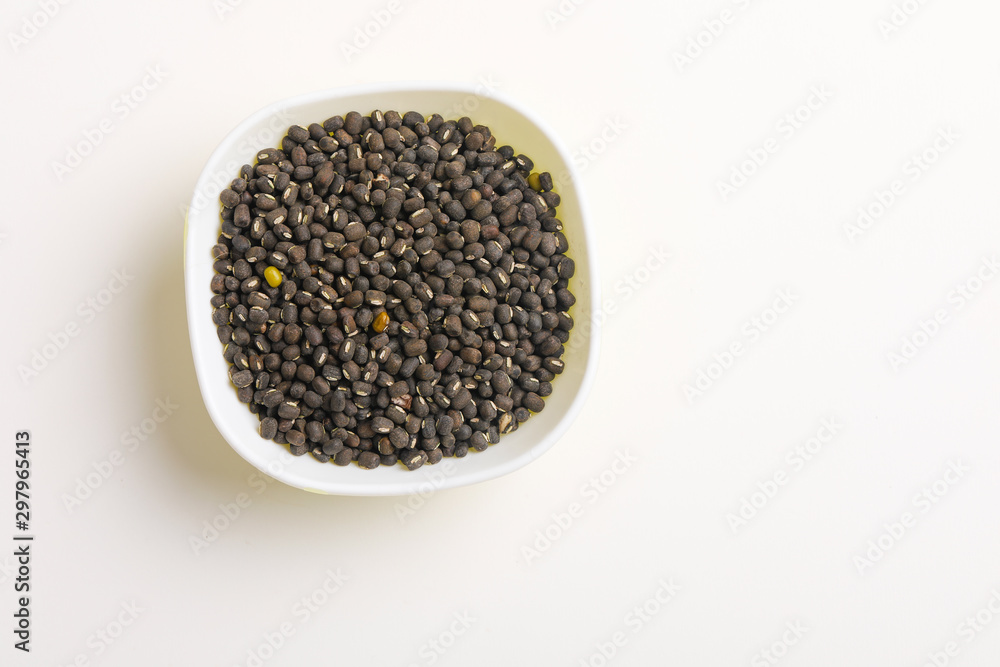 black gram seed or udad beans in bowl on white background black gram seed or udad beans in bowl on white background