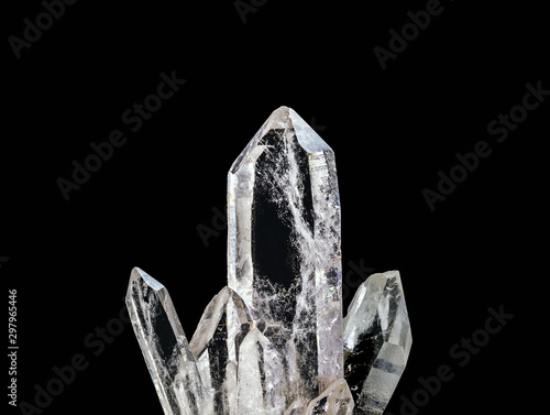 Macro photography of natural minerals from geological collection - clear quartz stone (rhinestone) on isolated black background. Zen meditation or relaxation concept.