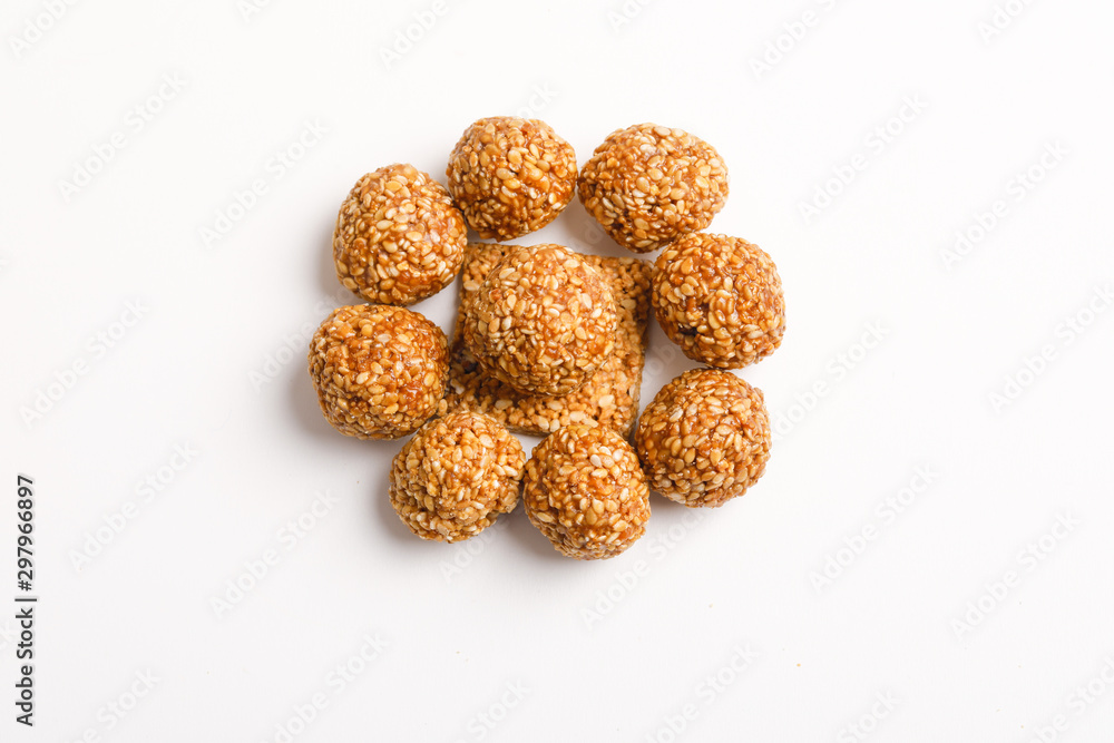 Indian sweet dish,Sesame seeds ball or called in hindi, til ke laddu on white background Indian sweet dish,Sesame seeds ball or called in hindi, til ke laddu on white background