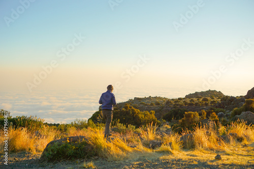 Guys sit and look forward.The stones are layers background Kilimanjaro Mountain in Tanzania