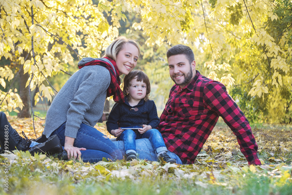 Happy family mother father and baby in autumn park playing with leaves. Happy family mother father and baby in autumn park playing with leaves.