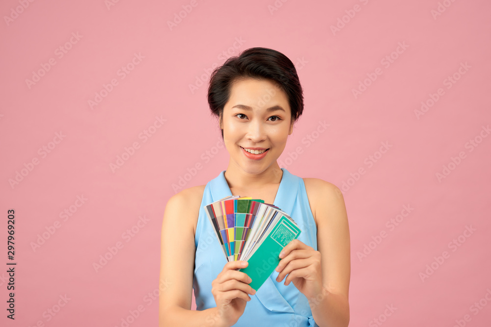 Pretty female designer showing color palette Pretty female designer showing color palette