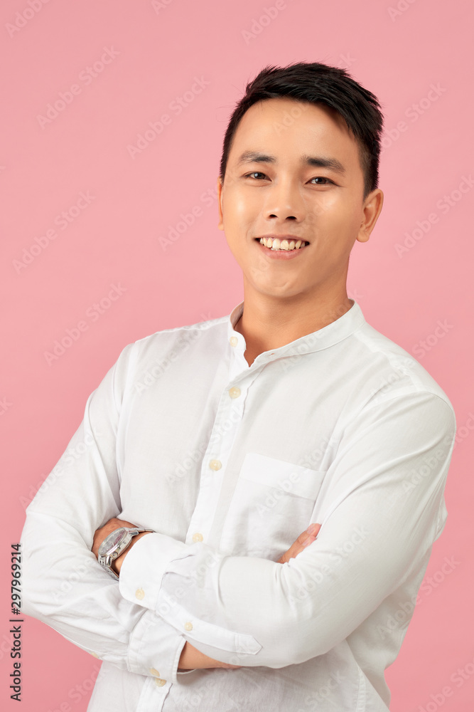 Young Asian male smiling and laughing with arms crossed Young Asian male smiling and laughing with arms crossed