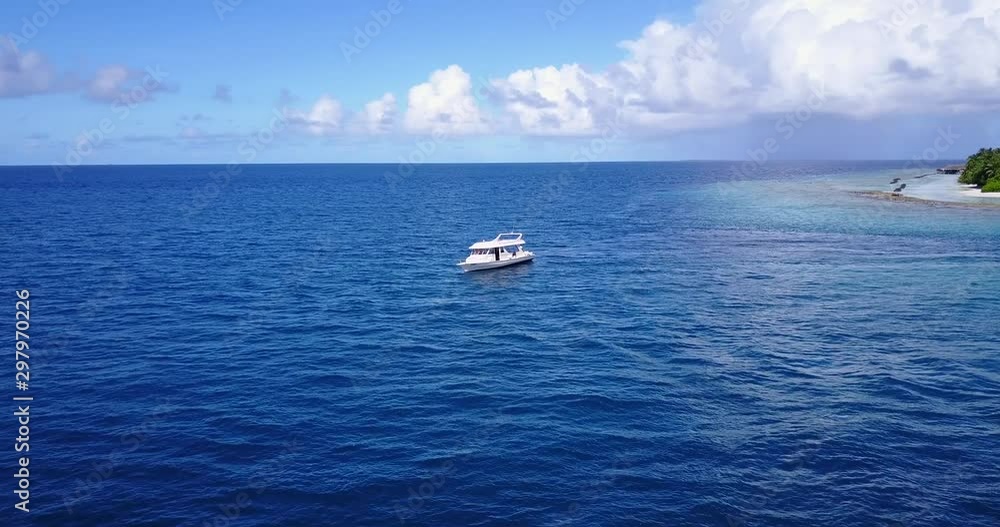 Touring boat with tourists anchored to crystal clear lagoon on the tropical island in Cook Islands Touring boat with tourists anchored to crystal clear lagoon on the tropical island in Cook Islands