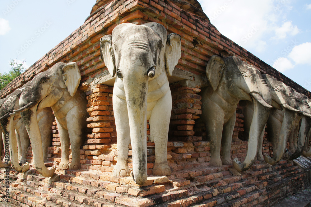 elephant statues around old pagodas in the old city of sukhothai, world heritage