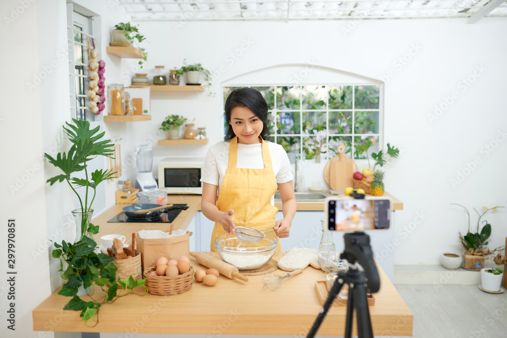 Young asian woman recording video for her blog