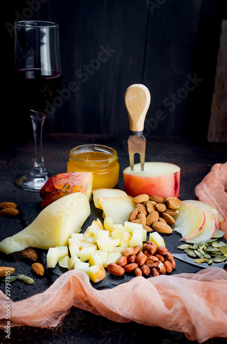 Cheese platter and glass of red wine photo