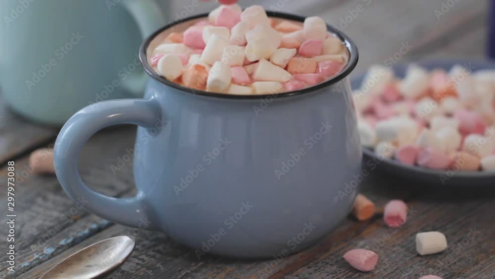 Merry Christmas! Christmas tree-shaped gingerbread cookie near cups of cocoa and marshmallows. Beautiful blurred christmas tree background with luminous garland. Merry Christmas! Christmas tree-shaped gingerbread cookie near cups of cocoa and marshmallows. Beautiful blurred christmas tree background with luminous garland.