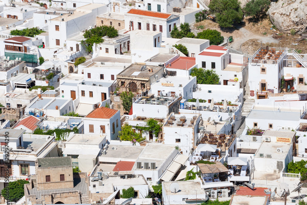 Restaurants on roofs on the houses in historic center of Lindos, Greece
