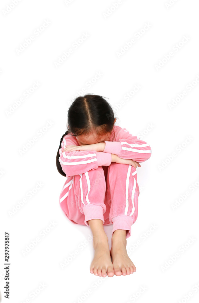 Sad alone and depressed of little Asian child girl sitting over white background. Family relationship concept. Sad alone and depressed of little Asian child girl sitting over white background. Family relationship concept.