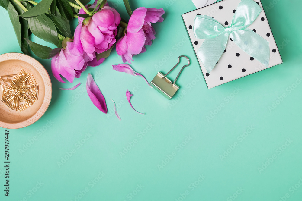 Beautiful peonies and giftbox on the trendy mint color background Beautiful peonies and giftbox on the trendy mint color background