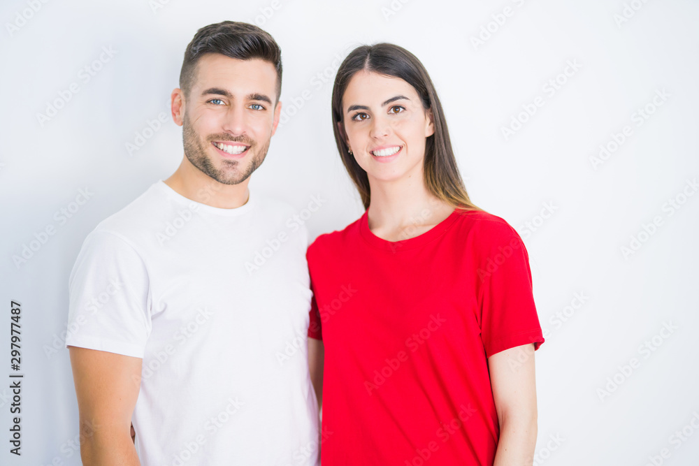 Young beautiful couple in love hugging over white isolated background Young beautiful couple in love hugging over white isolated background