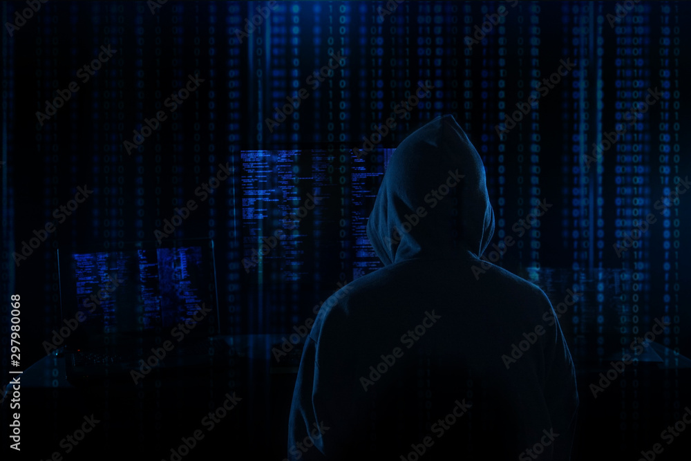 Internet crime concept. Hacker working on a code on dark digital background with digital interface around. Internet crime concept. Hacker working on a code on dark digital background with digital interface around.
