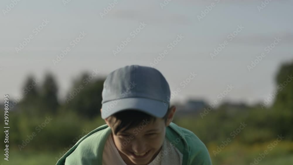boy laughs and looks at the camera outdoors, have fun boy laughs and looks at the camera outdoors, have fun
