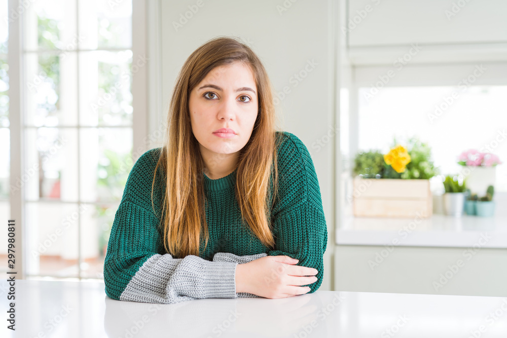 Young beautiful plus size woman wearing casual striped sweater Relaxed with serious expression on face. Simple and natural looking at the camera. Young beautiful plus size woman wearing casual striped sweater Relaxed with serious expression on face. Simple and natural looking at the camera.