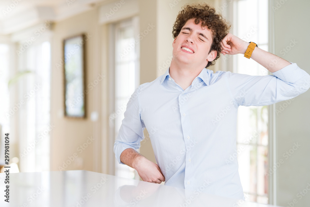 Young business man with curly read head stretching back, tired and relaxed, sleepy and yawning for early morning Young business man with curly read head stretching back, tired and relaxed, sleepy and yawning for early morning