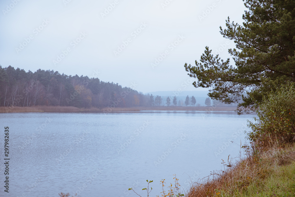 autumn landscape view of lake misty weather