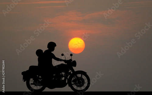  silhouette fatherand son ride classic motorcycle on sunset