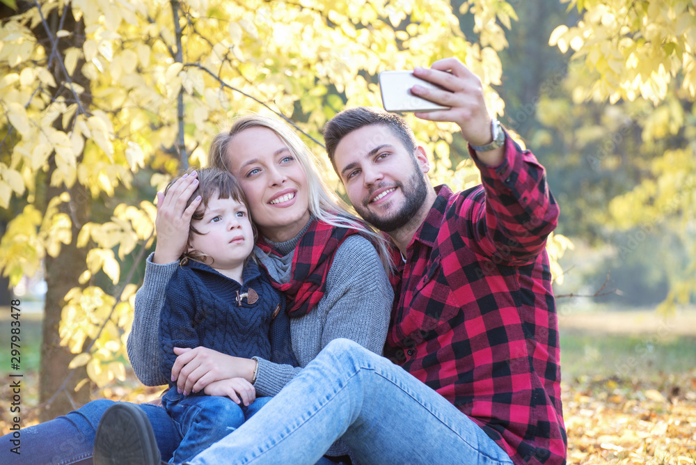 Happy family taking a selfie together outdoors