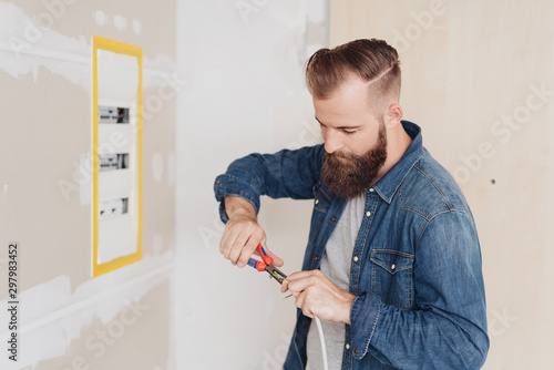 Electrician installing wiring on a control panel photo