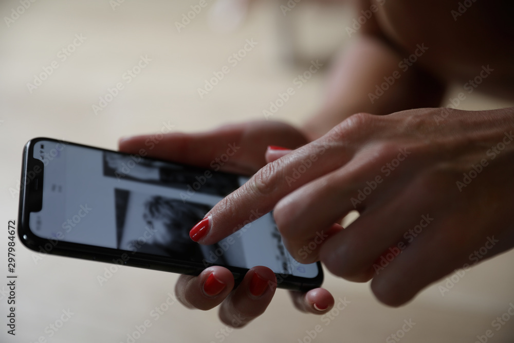 Close up shot of woman hand using her smart phone.