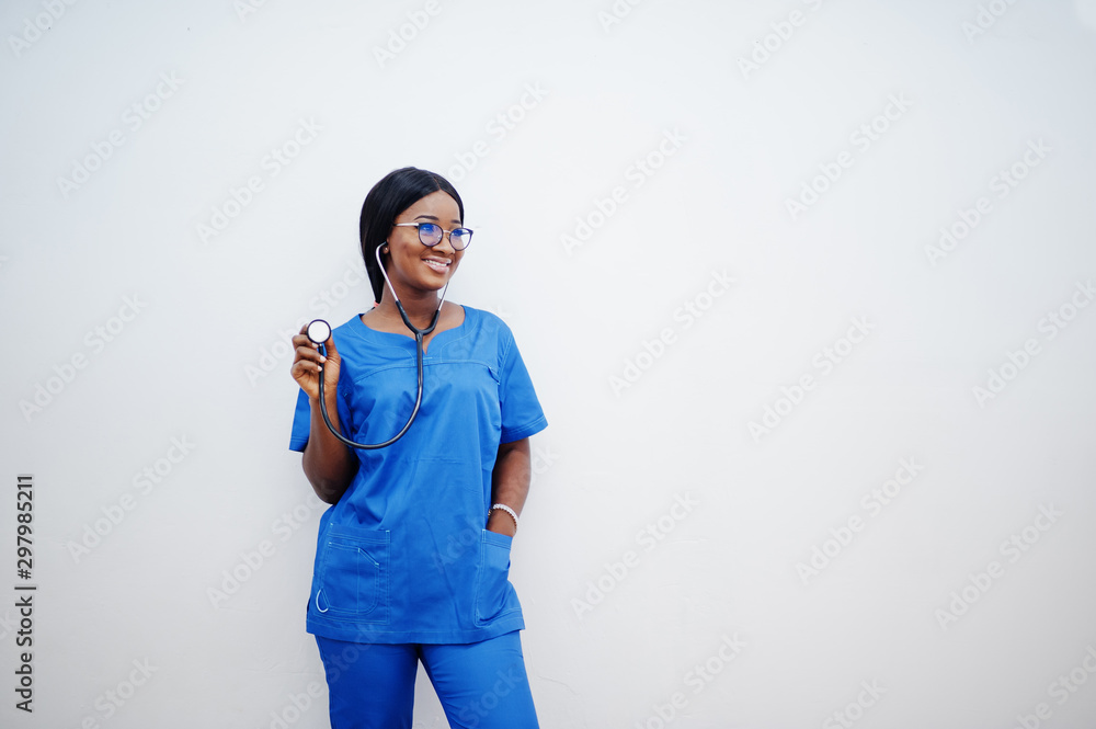Portrait of happy female african american young doctor pediatrician in blue uniform coat and stethoscope isolated on white. Healthcare, medical, medicine specialist - concept. Portrait of happy female african american young doctor pediatrician in blue uniform coat and stethoscope isolated on white. Healthcare, medical, medicine specialist - concept.